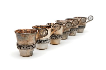 Image showing Row of six vintage silver cups isolated