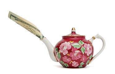 Image showing Teapot with dollar bill sticking out of its spout isolated 