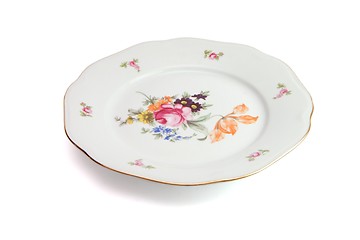 Image showing White dinner plate with flowers and wavy rim isolated