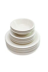 Image showing Stack of plain beige dinner and soup plates and saucers isolated