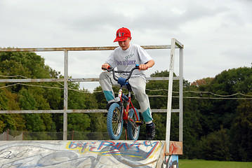 Image showing Young boy rides bicycle