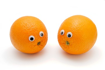 Image showing Two funny orange fruits with eyes isolated