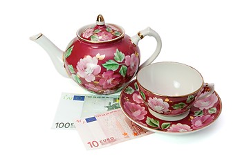 Image showing Tea service stands on euro banknotes isolated 