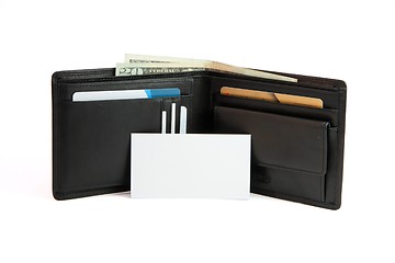 Image showing White business card in front of black wallet isolated