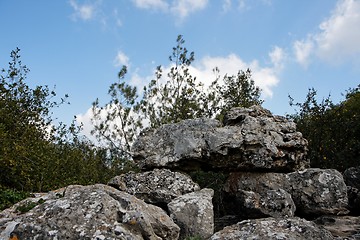 Image showing Pyramid of lichen-covered gray rocks in cloudy day