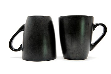 Image showing Two black coffee cups up and down isolated