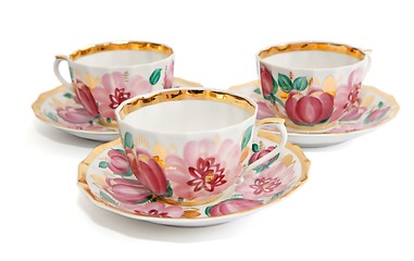 Image showing Three floral-painted tea cups with saucers isolated 