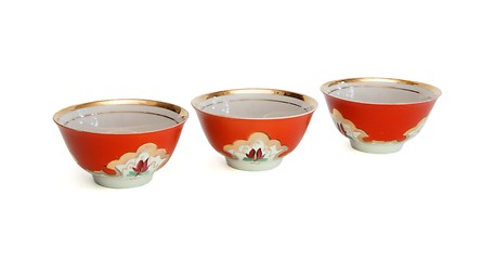 Image showing Three red porcelain drinking bowls isolated 