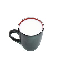 Image showing Black cup with red rim full of milk isolated