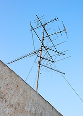 Image showing Old television aerial on roof against blue sky