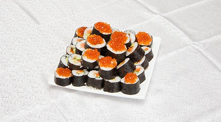 Image showing Homemade sushi with red caviar on white square plate 