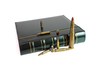 Image showing Dark book and cartridges of various calibers isolated