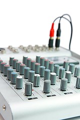 Image showing Controls of small sound mixer console with attached plug isolated