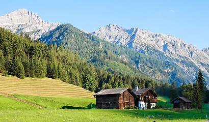Image showing Alpine landscape in Austria: mountains, forests, meadows and a farm
