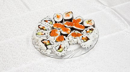 Image showing Homemade sushi of several types with red caviar on glass plate 