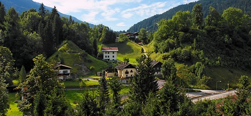 Image showing Alpine village under the mountains at sunrise