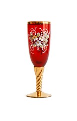 Image showing Beautiful red wine glass with flower pattern and a golden stem isolated