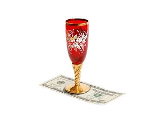 Image showing Beautiful red wine glass  with golden stem on twenty dollar bill isolated