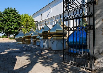 Image showing Row of onion church domes on the ground 