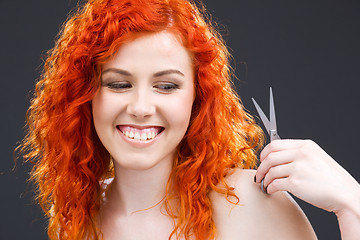 Image showing redhead with scissors