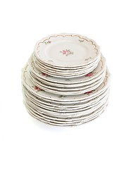 Image showing High stack of white dinner plates and saucers isolated