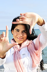 Image showing Beautiful young woman framing her face