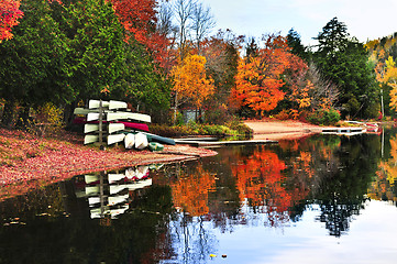 Image showing Fall forest reflections with canoes