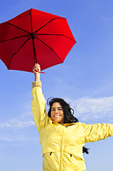 Image showing Beautiful young woman in raincoat with umbrella