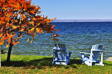 Image showing Wooden chairs on autumn lake