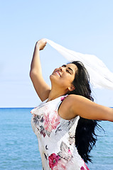 Image showing Beautiful young woman at beach with white scarf