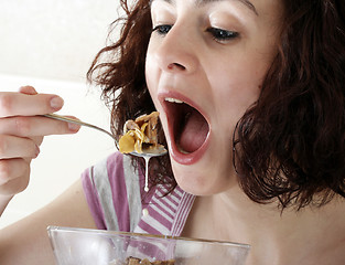 Image showing Young people eating milk with cereals