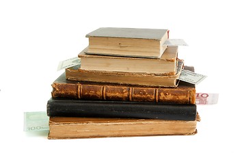 Image showing Stack of old books with banknote bookmarks isolated 