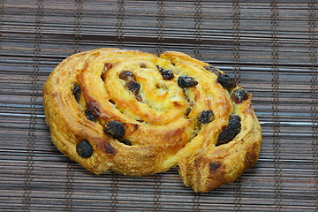 Image showing Freshly baked cinnamon roll on bakery paper 