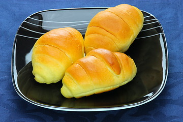 Image showing Close-up  bread loaf stacked on a black plate