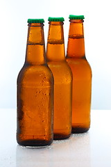 Image showing Three beer bottles abreast