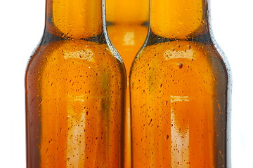 Image showing Upper part of three beer bottles