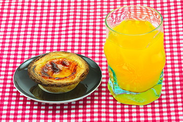 Image showing glass of orange juice and cake