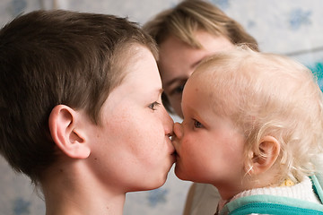 Image showing elder brother kisses little sister