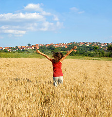 Image showing Happy girl jumping in wheat field