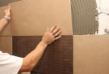 Image showing laying ceramic tile on wall