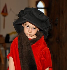 Image showing Serious cute little boy in medieval costume standing 