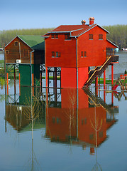 Image showing Red houses and flooding river