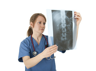 Image showing Young nurse studying x-ray