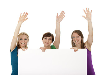 Image showing Three young women holding a banner and greeting