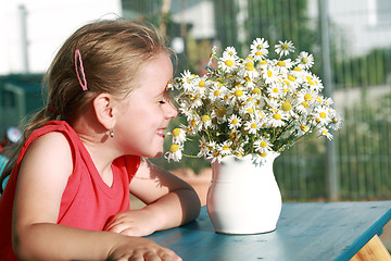 Image showing Little girl with chamomile