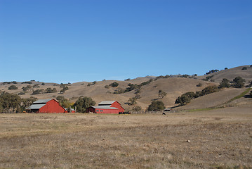 Image showing Red barn & brown hills