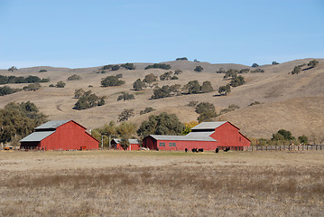 Image showing Red barn & brown hills