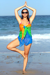 Image showing Woman doing yoga exercise on the beach