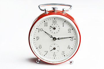 Image showing Old red analog alarm clock.