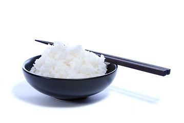 Image showing Black bowl with white rice and chop sticks